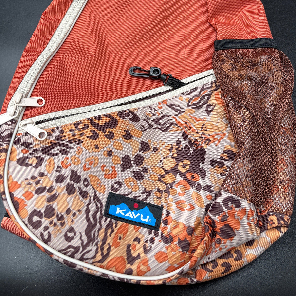 KAVU NWT Cross Body Paxton Pack Go Wild close-up showing durable materials and vibrant design.