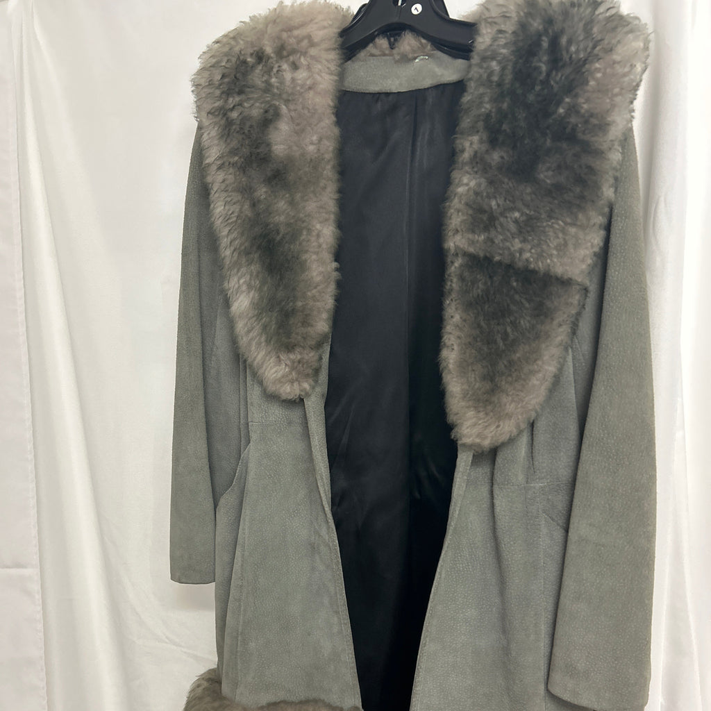 A long gray suede-like coat with large gray faux-fur trim around the collar, front opening, and hem, hanging on a black hanger against a white draped fabric backdrop.