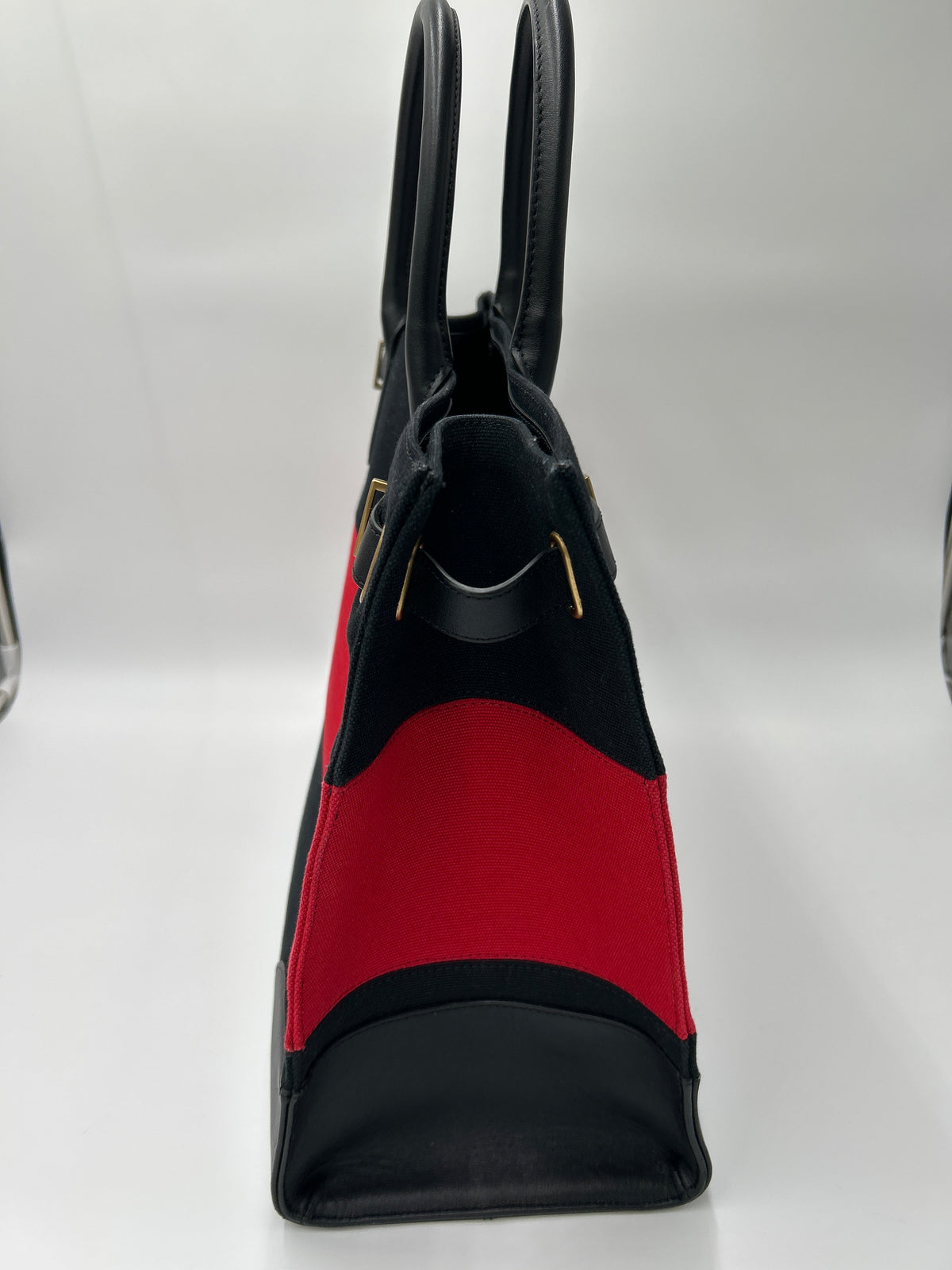NWOT Ralph Lauren Two-Tone Devyn Canvas Tote w/2 RL storage bags side view showcasing black and festive red design.