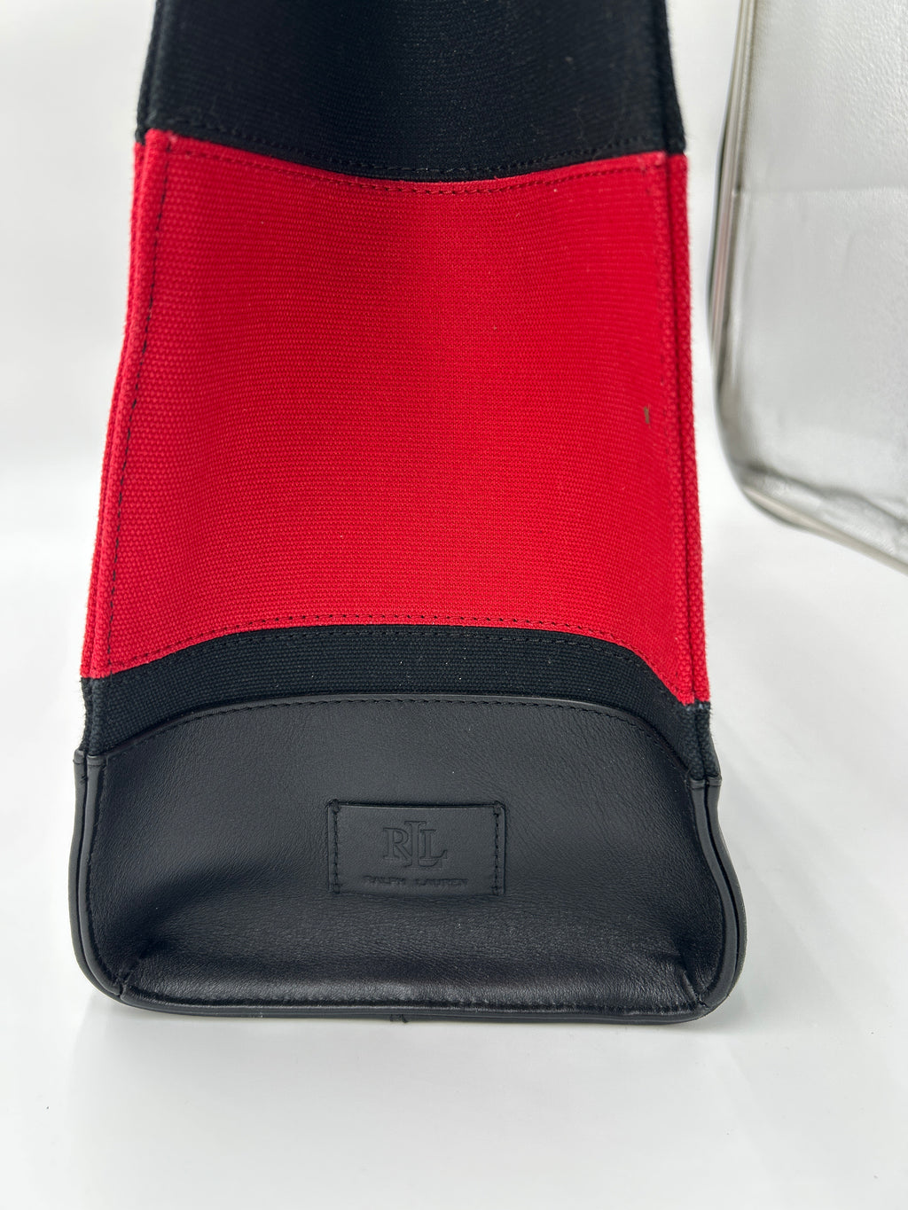 NWOT Ralph Lauren Two-Tone Devyn Canvas Tote w/2 RL storage bags close-up of red and black canvas fabric with leather trim.