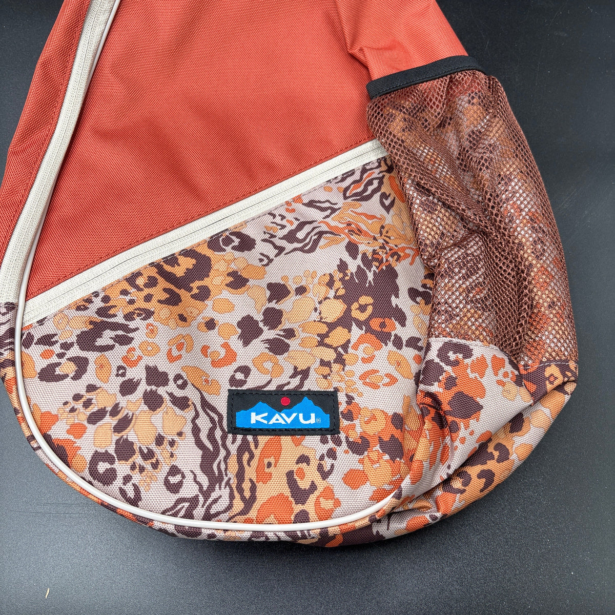KAVU NWT Cross Body Paxton Pack Go Wild close-up showcasing the vibrant pattern and durable fabric.