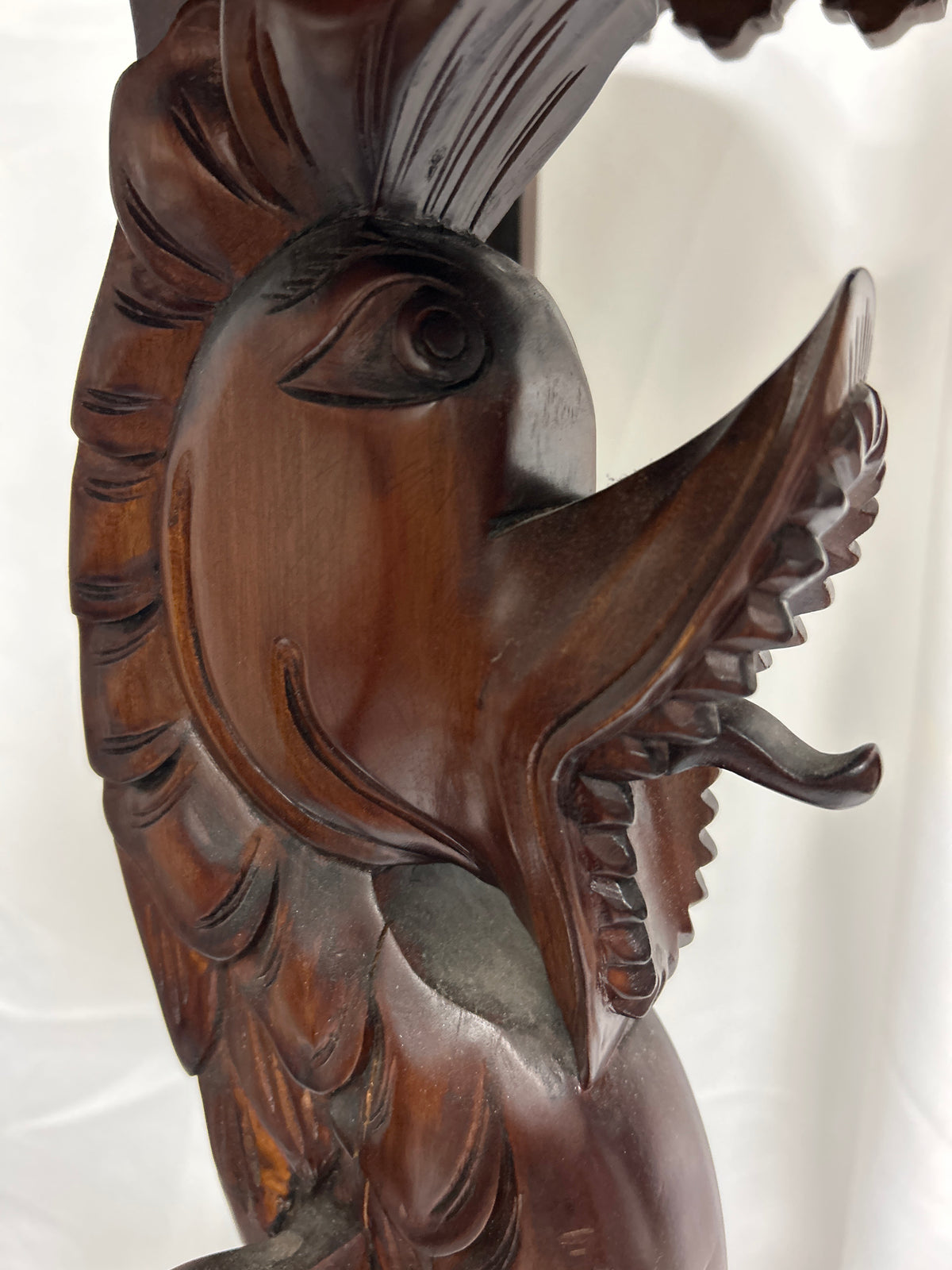 Detailed close-up of the carved dragon detail on the Carved Dragon Pedestal Table, showcasing intricate craftsmanship.