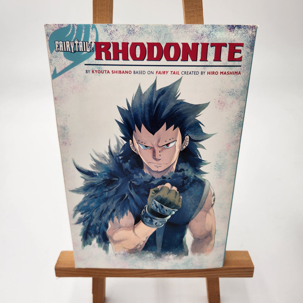 A vertical book cover print of the manga 'Saiyuri no Rhodonite' displayed on a wooden easel against a plain white background.