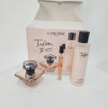 Lancôme Térbon Paris 30th anniversary gift set featuring a perfume bottle, a sample spray vial, a body mist bottle, and a lotion bottle arranged in front of their original pink packaging box.