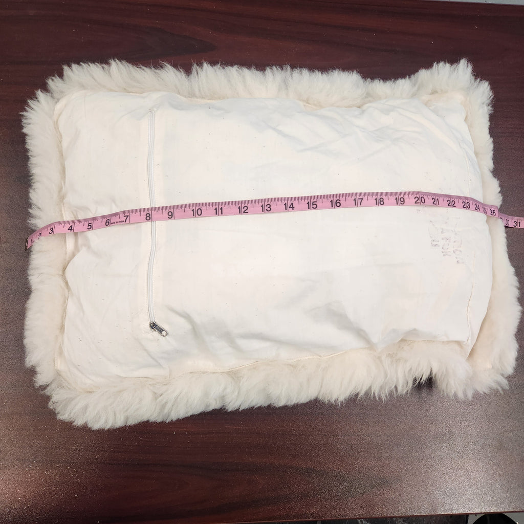 Vintage alpaca fur penguin pillow from Peru, front view of the black penguin motif on ivory plush fur measurement