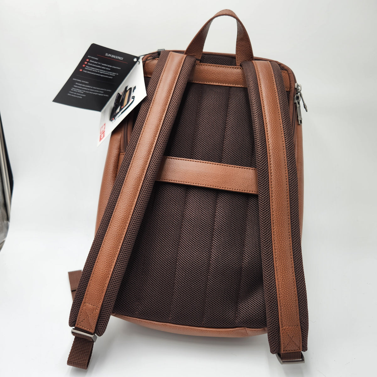 Samsonite Brown backpack shown from the back, featuring a dark brown mesh back panel, tan faux-leather shoulder straps and top handle, and attached product tags on a white studio background.