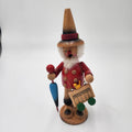Vintage German Wood Smoker Erzgebirge Handcrafted figurine with red coat, holding an umbrella and toy cart.