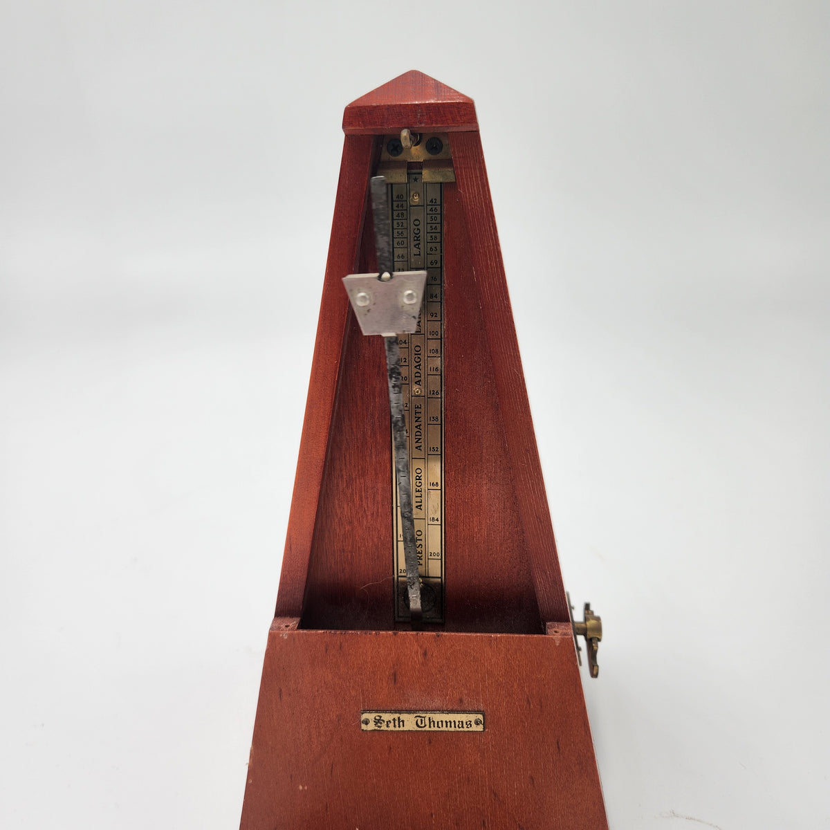 Seth Thomas wooden pyramid metronomes showcasing a close-up view of the metronome mechanism and markings.