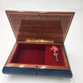 Reuge (Swiss Movement) / Italian Sorrento Music Box showing the interior with plush red lining and decorative key.