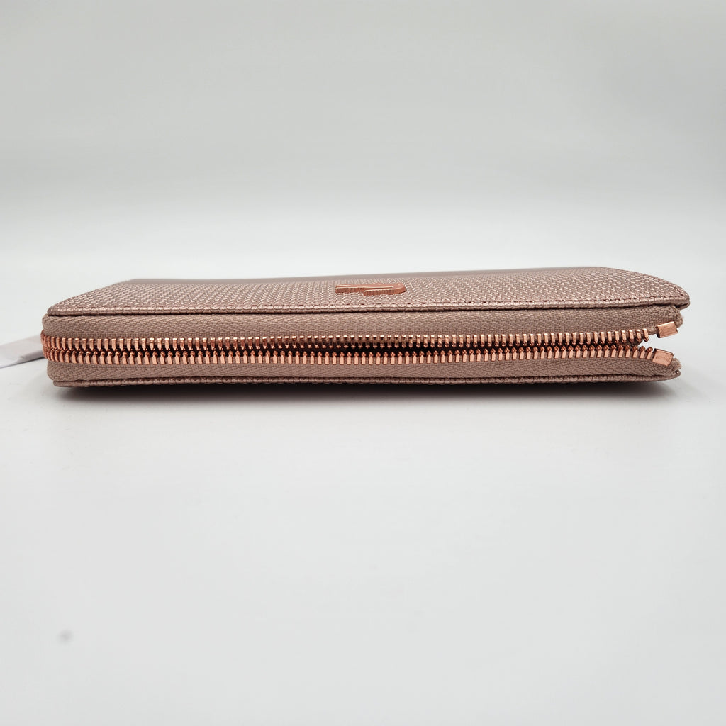 NWT Lacoste Chantaco Rose Gold Metallic Pique Leather Large Zip Around Wallet Clutch side view showcasing zip detail.