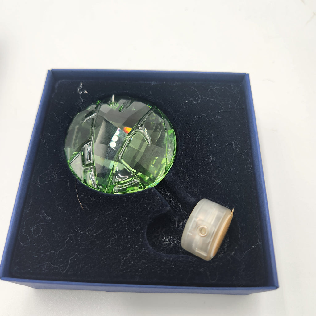Swarovski Austrian Crystal 2008 Round Green Membership Window Ornament displayed in a blue box, showcasing its exquisite green faceted design.