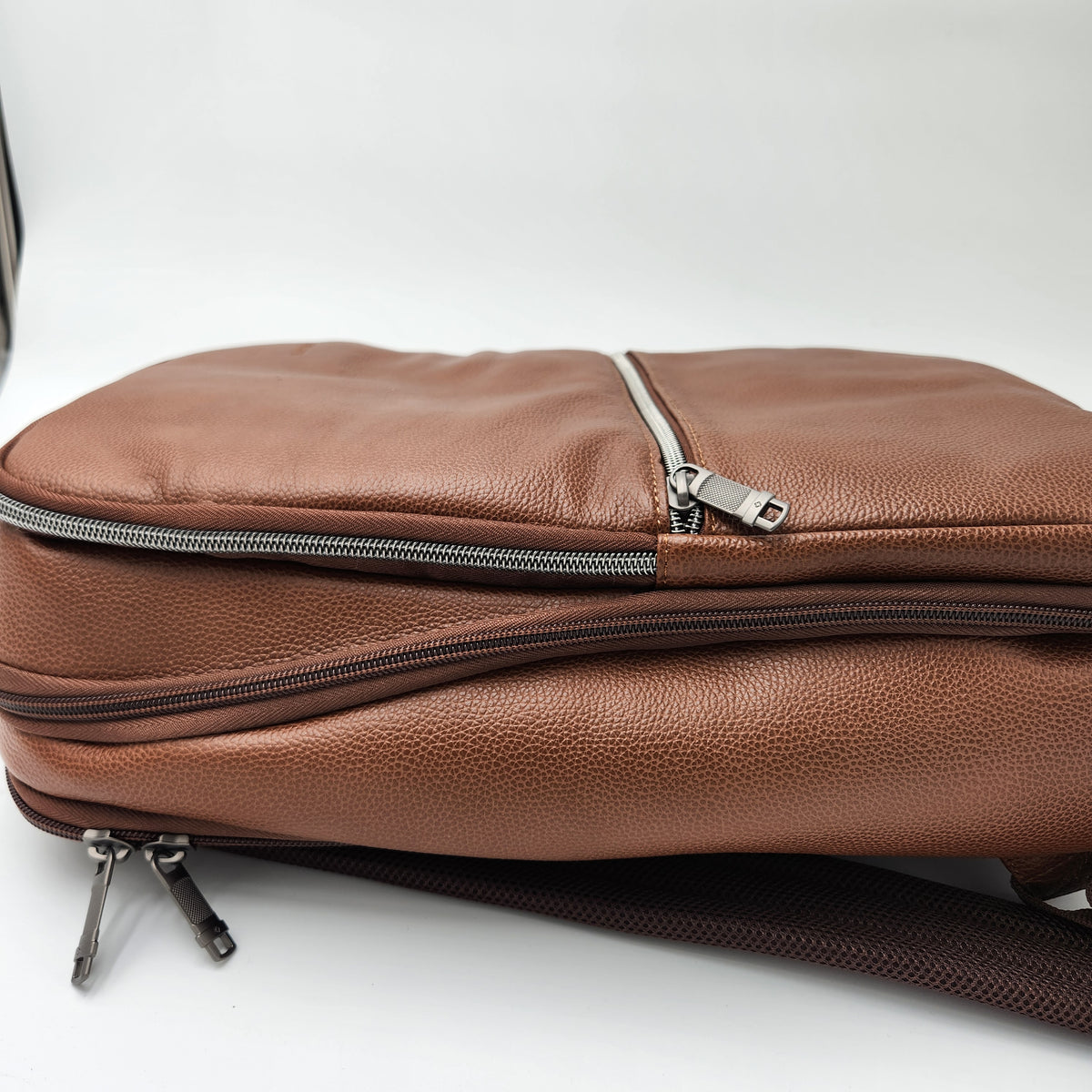 A brown pebbled leather crossbody bag by Samsonite with silver zippers, shown on a plain white background.