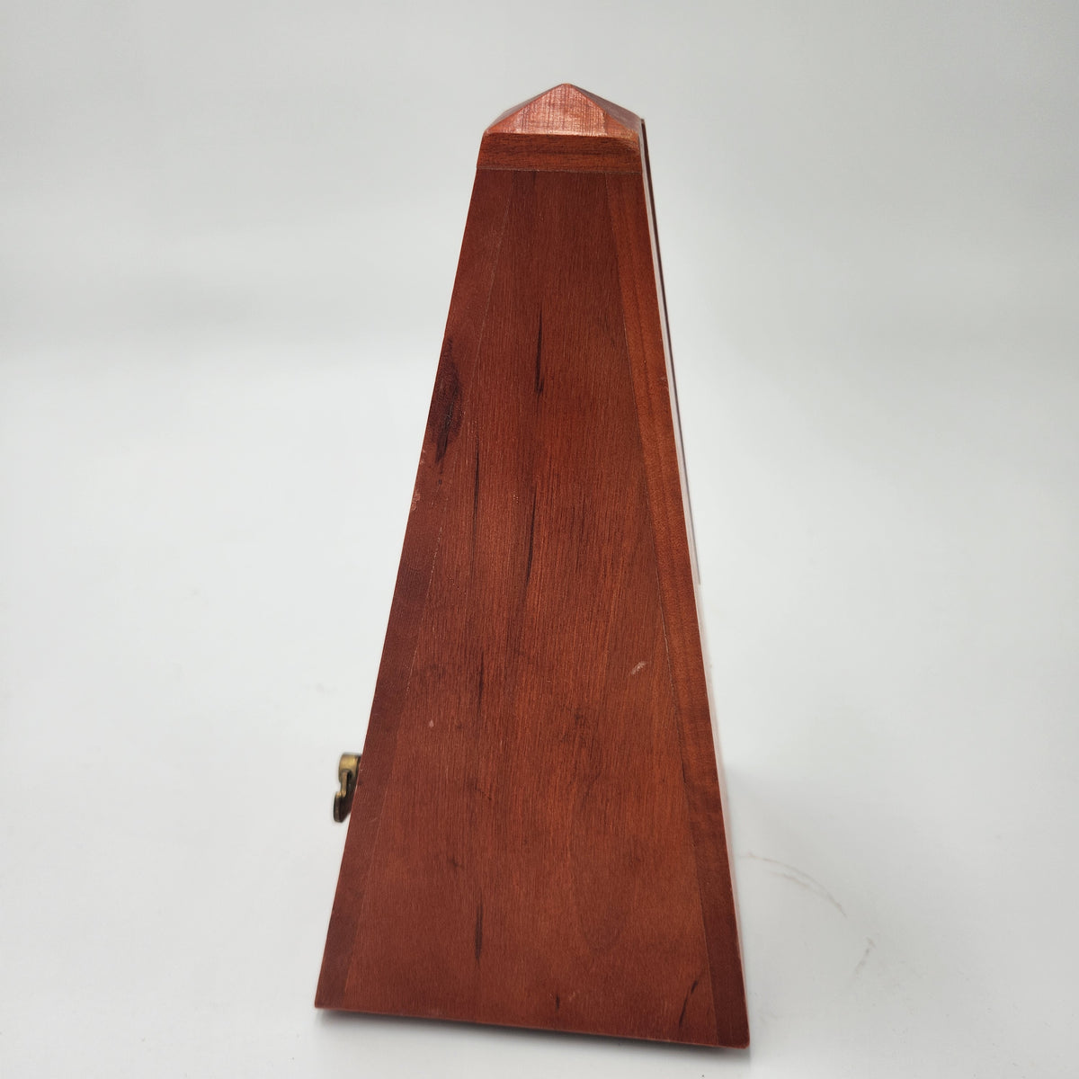 Seth Thomas wooden pyramid metronomes side view showcasing smooth wooden finish and classic pyramid shape.