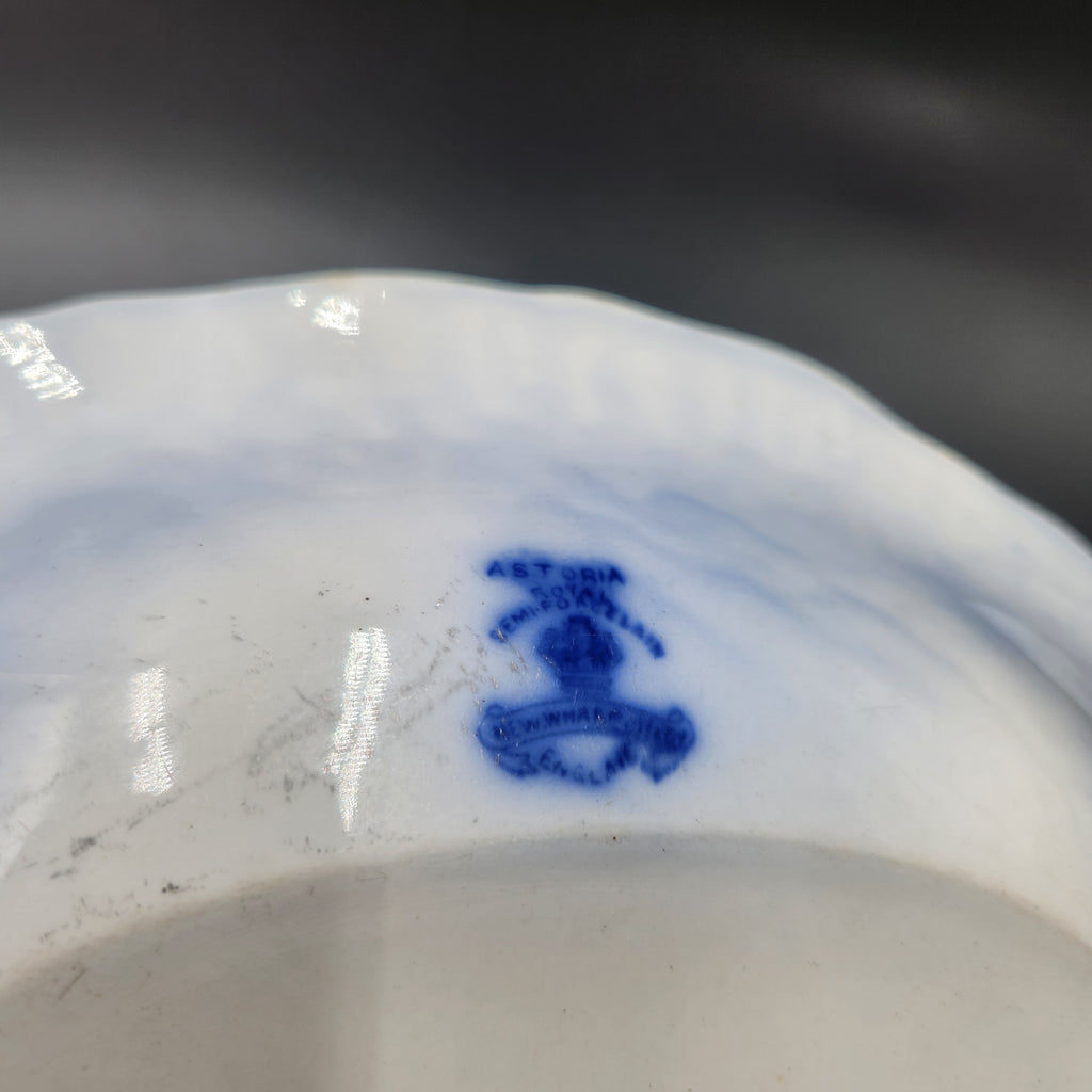 Close-up of the inside of a white porcelain plate or dish, showing a small blue monogram or maker's mark near the center. Antique 1890s Flow Blue Cobalt Oval Serving Bowl Deep Vegetable Dish