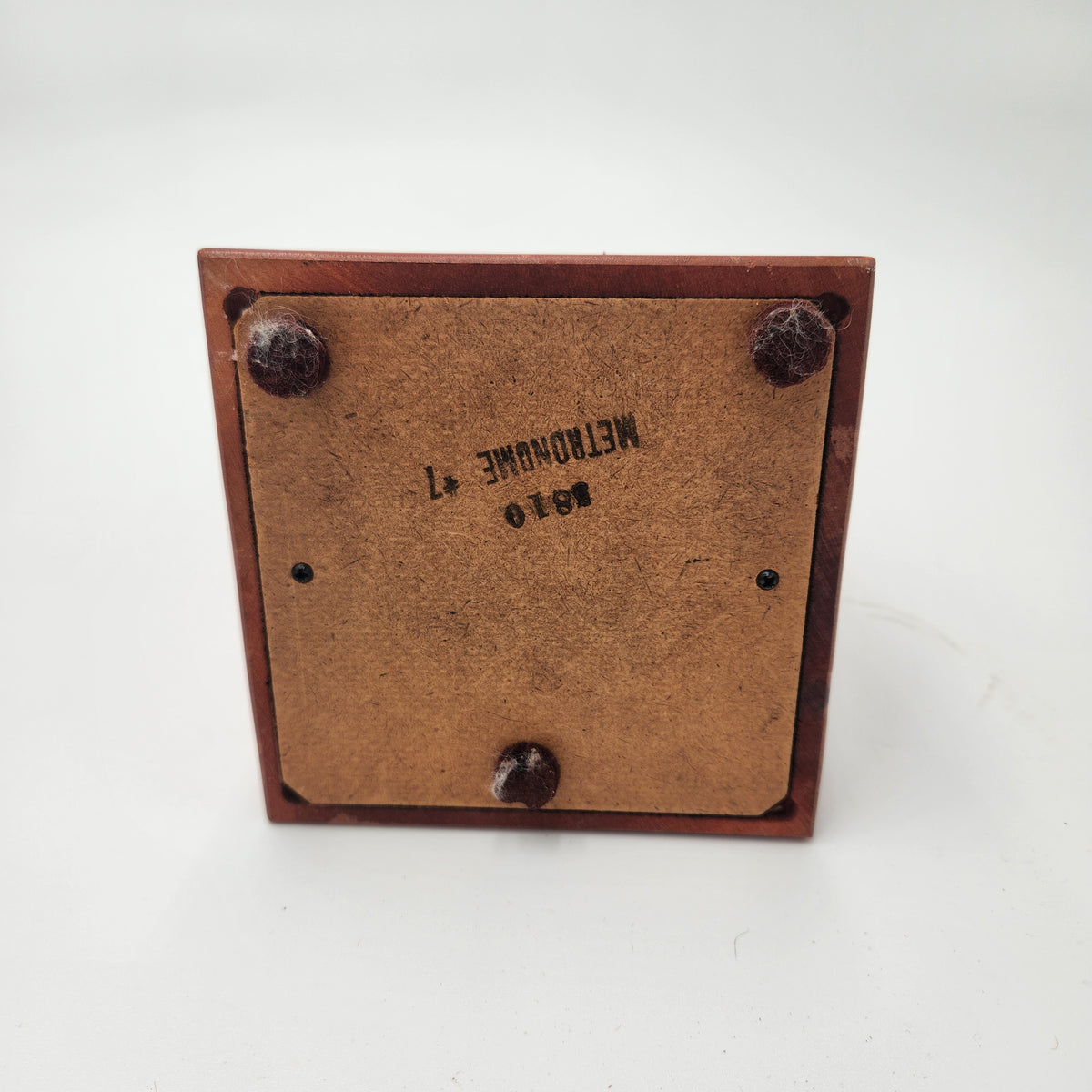 Seth Thomas wooden pyramid metronomes base showing felt pads and model number for vintage musical timing.