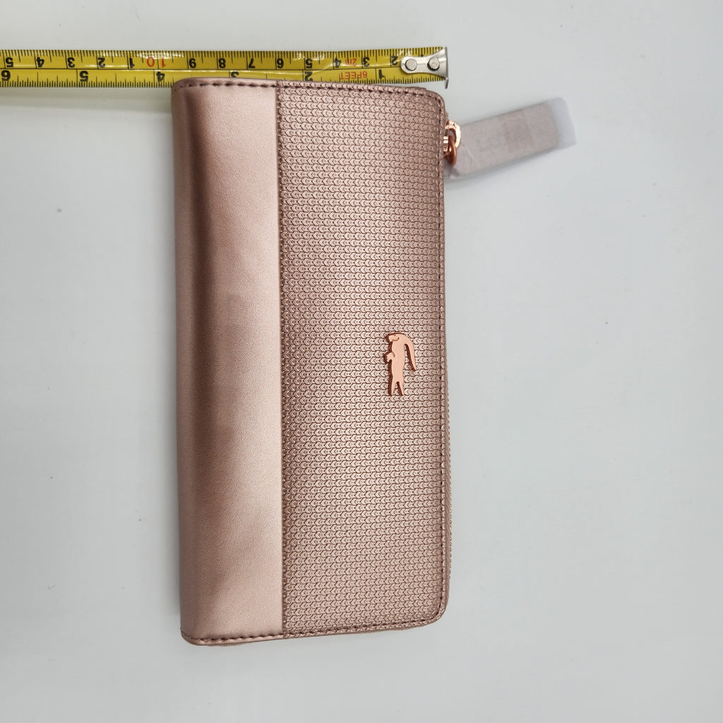NWT Lacoste Chantaco Rose Gold Metallic Pique Leather Large Zip Around Wallet Clutch shown with measuring tape for size reference.
