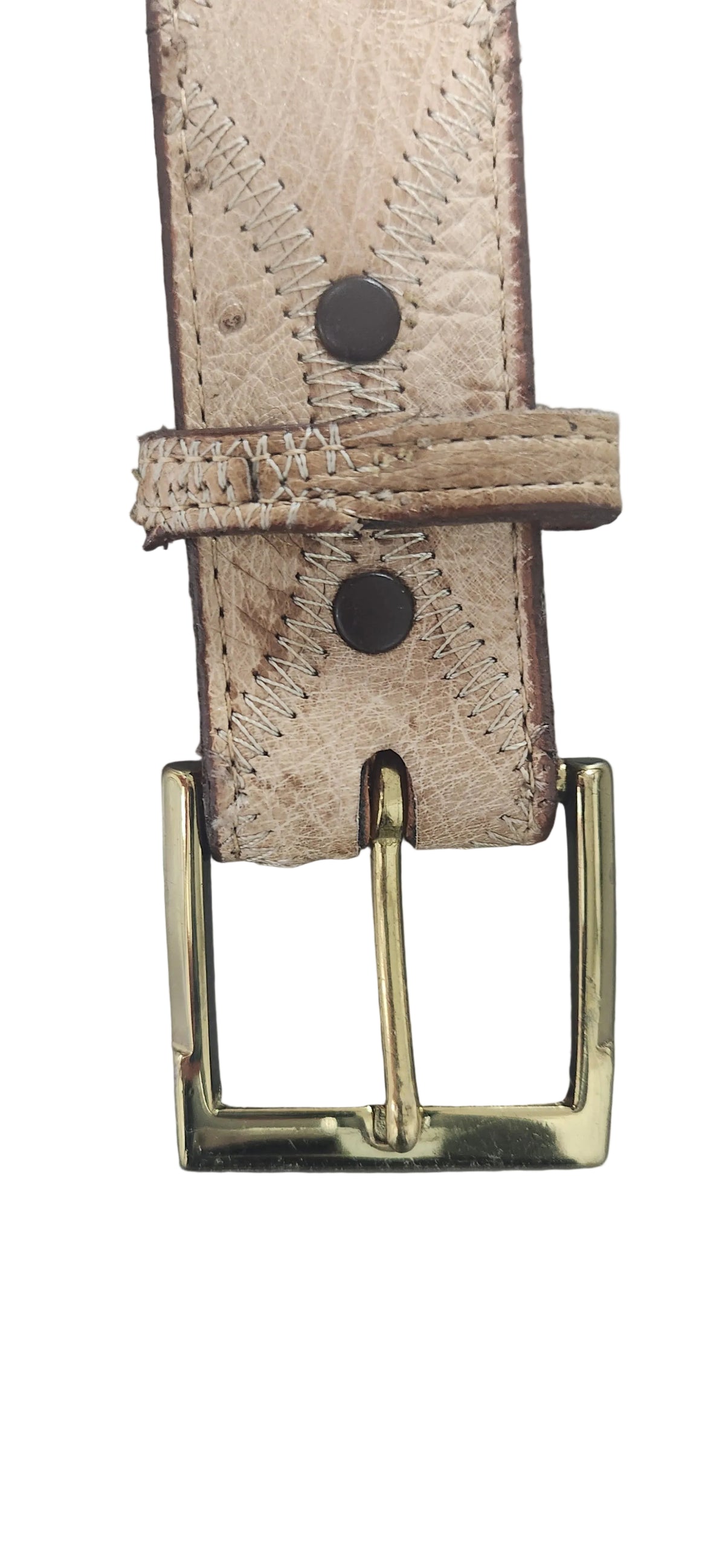 A close-up of a light beige leather belt strap with a distressed, textured finish and a gold-tone metal buckle, shown against a neutral gray background. Justin Genuine Ostrich Belt