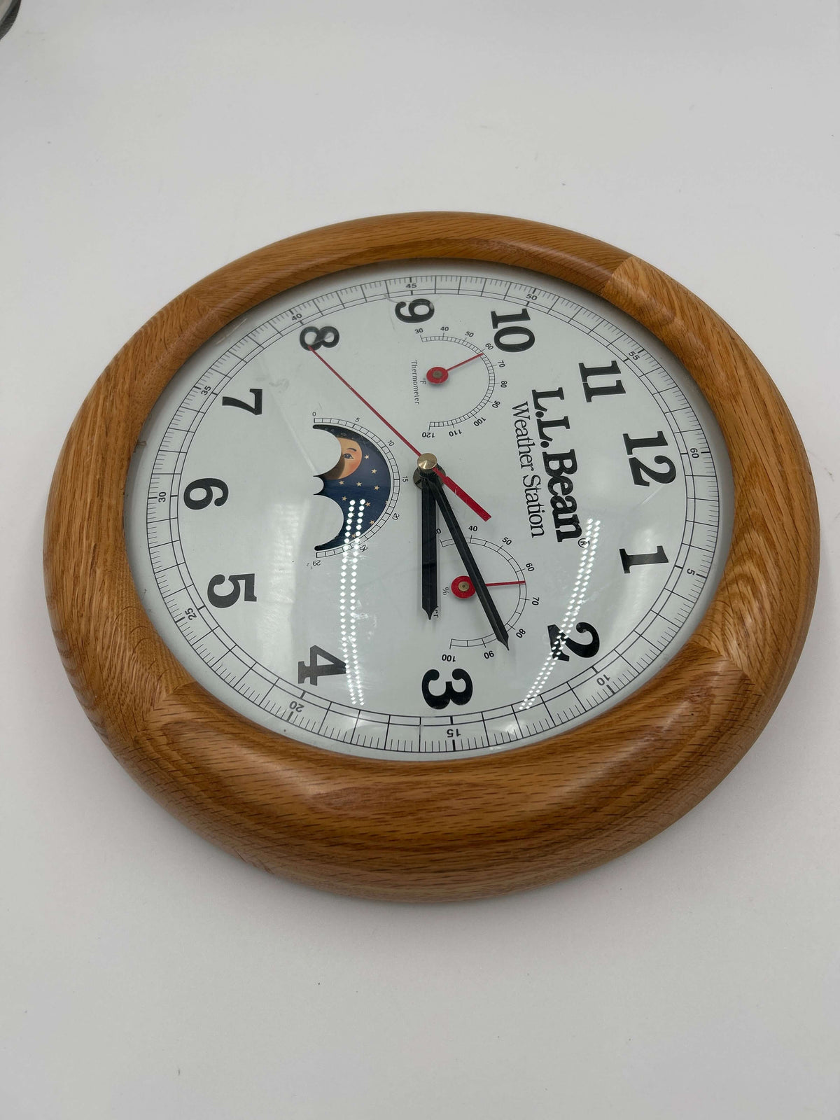 Vintage LL Bean Weather Station Wall Clock with solid oak frame and black Arabic numerals on white face.